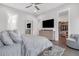 Bedroom with access to a walk-in closet, featuring hardwood floors, tv and decorative art piece at 687 Banton Nw Dr, Atlanta, GA 30318