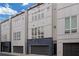 Modern townhome featuring sleek architectural design, multi-story facade, and attached garage at 687 Banton Nw Dr, Atlanta, GA 30318