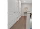 Hallway featuring hardwood floors, white walls, and decorative art piece at 687 Banton Nw Dr, Atlanta, GA 30318