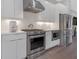 This modern kitchen features white cabinets, stainless steel appliances, and hardwood floors at 687 Banton Nw Dr, Atlanta, GA 30318