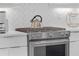 This modern kitchen features a stainless steel oven, range, and white cabinets at 687 Banton Nw Dr, Atlanta, GA 30318