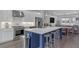 This modern kitchen features white cabinets, an island with seating, and stainless steel appliances at 687 Banton Nw Dr, Atlanta, GA 30318