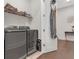 Well-organized laundry room with modern appliances, shelving and space-saving ironing board at 687 Banton Nw Dr, Atlanta, GA 30318