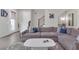 Spacious living area features a plush gray sofa, cozy rug, hardwood floors, and an open floor plan perfect for entertaining at 687 Banton Nw Dr, Atlanta, GA 30318
