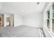 Spacious carpeted bedroom featuring neutral walls and a large window bringing in plenty of light at 1411 Stephens View Dr, Loganville, GA 30052