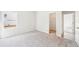 A carpeted bedroom shows a large window, closet, and an open doorway leading to another room at 1411 Stephens View Dr, Loganville, GA 30052