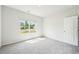 Bright bedroom featuring plush carpeting and a large window showcasing a pleasant neighborhood view at 1411 Stephens View Dr, Loganville, GA 30052