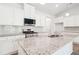 Modern kitchen featuring granite countertops, stainless steel appliances, and white cabinetry at 1411 Stephens View Dr, Loganville, GA 30052