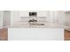 Close-up of kitchen island with granite counters, sink, and modern fixtures at 1411 Stephens View Dr, Loganville, GA 30052