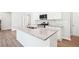 Spacious kitchen island features granite countertops, sink, and stainless steel appliances at 1411 Stephens View Dr, Loganville, GA 30052