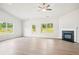 Bright living room with hardwood floors, fireplace, and natural light at 1411 Stephens View Dr, Loganville, GA 30052