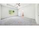 Spacious main bedroom features plush carpeting, a ceiling fan, and ample natural light at 1411 Stephens View Dr, Loganville, GA 30052