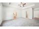 Spacious main bedroom features plush carpeting, a ceiling fan, and ample natural light at 1411 Stephens View Dr, Loganville, GA 30052