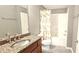 Bathroom features vanity with granite countertop, shower and tub combo at 2700 Pine Tree Ne Rd # 3009, Atlanta, GA 30324