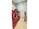 Laundry room features modern red washer and dryer units at 2700 Pine Tree Ne Rd # 3009, Atlanta, GA 30324