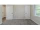 Bedroom with a view to the hallway and closet and large windows with blinds at 4029 Moffat Ct, Decatur, GA 30035