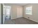 Neutral bedroom with gray carpet, closet and window, leading to hallway at 4029 Moffat Ct, Decatur, GA 30035