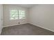 Cozy bedroom with carpeted floors, neutral paint, and a large window with blinds at 4029 Moffat Ct, Decatur, GA 30035