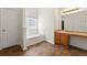 Bathroom boasts tile floor, a soaking tub, bright window, and a long vanity at 7495 Garnet Dr, Jonesboro, GA 30236