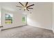 Bedroom featuring neutral carpet, two bright windows, a ceiling fan and lots of light at 7495 Garnet Dr, Jonesboro, GA 30236