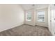 Bedroom featuring neutral carpet, bright double windows, and lots of natural light at 7495 Garnet Dr, Jonesboro, GA 30236