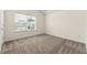 Bedroom featuring plush carpeting, a bright window, and neutral color palette at 7495 Garnet Dr, Jonesboro, GA 30236