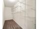 Walk-in closet boasting multiple shelves and hanging racks for easy storage and organization at 7495 Garnet Dr, Jonesboro, GA 30236