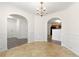 Formal dining room features wainscoting, tile floor and a chandelier light fixture at 7495 Garnet Dr, Jonesboro, GA 30236