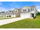 Exterior view of homes showing well-maintained lawns, driveways, and attached garages at 7495 Garnet Dr, Jonesboro, GA 30236