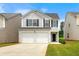 Charming two-story home featuring a two-car garage and well-maintained lawn at 7495 Garnet Dr, Jonesboro, GA 30236