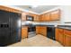 Kitchen with stainless steel appliances and wood cabinets offers a functional and stylish space at 7495 Garnet Dr, Jonesboro, GA 30236