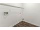 Empty laundry room features practical vinyl flooring, wire shelving, and utility connections at 7495 Garnet Dr, Jonesboro, GA 30236