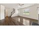 Cozy living room features hardwood floors, a staircase, and a view of the front yard at 7495 Garnet Dr, Jonesboro, GA 30236