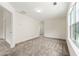 Bright living room features neutral carpet, a large window and ample natural light at 7495 Garnet Dr, Jonesboro, GA 30236