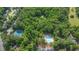 Aerial view of a community with tennis courts and a pool surrounded by lush greenery and homes at 9480 Coleman Rd, Roswell, GA 30075