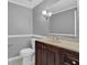 Bathroom featuring a dark wooden vanity, modern fixtures, and a large mirror at 9480 Coleman Rd, Roswell, GA 30075