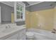 Bathroom featuring a tiled bathtub, window with bright natural light and modern fixtures at 9480 Coleman Rd, Roswell, GA 30075