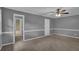 Spacious bedroom featuring neutral carpet, light gray walls with white trim, and access to ensuite bathroom at 9480 Coleman Rd, Roswell, GA 30075