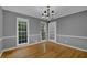 Bright dining room with natural light, hardwood floors, and two windows at 9480 Coleman Rd, Roswell, GA 30075
