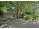 View of the two-car garage and a long driveway at 9480 Coleman Rd, Roswell, GA 30075