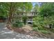 Charming two-story home with white trim, a front porch, and a stone walkway at 9480 Coleman Rd, Roswell, GA 30075