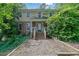 Two-story home with beige siding and a brick foundation at 9480 Coleman Rd, Roswell, GA 30075