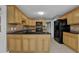 Spacious kitchen with tile flooring, black appliances, and light wood cabinets at 9480 Coleman Rd, Roswell, GA 30075