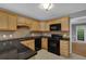 Kitchen with black appliances, tile backsplash, and granite countertops at 9480 Coleman Rd, Roswell, GA 30075