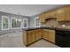 Kitchen with black appliances, wood cabinets, and a view of backyard at 9480 Coleman Rd, Roswell, GA 30075