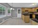 Eat-in kitchen with black appliances, tile flooring, and a window view at 9480 Coleman Rd, Roswell, GA 30075