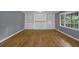 Spacious living room with wood floors, built-in bookshelves, and a fireplace at 9480 Coleman Rd, Roswell, GA 30075