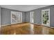 Living room with gray walls, two windows, and a glass paneled door at 9480 Coleman Rd, Roswell, GA 30075
