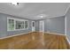 Spacious living room with wood floors and natural light from large windows at 9480 Coleman Rd, Roswell, GA 30075