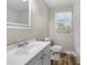 Bright bathroom with new vanity, modern fixtures, wood look tile floors, and marble tiled shower at 2159 Fairburn Sw Rd, Atlanta, GA 30331